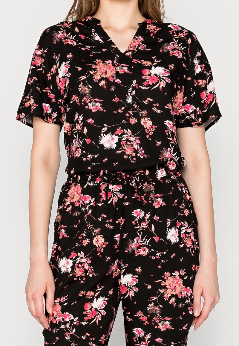 Black floral print two-piece outfit featuring short sleeves, a v-neck top, and elastic waistband pants with a drawstring detail.