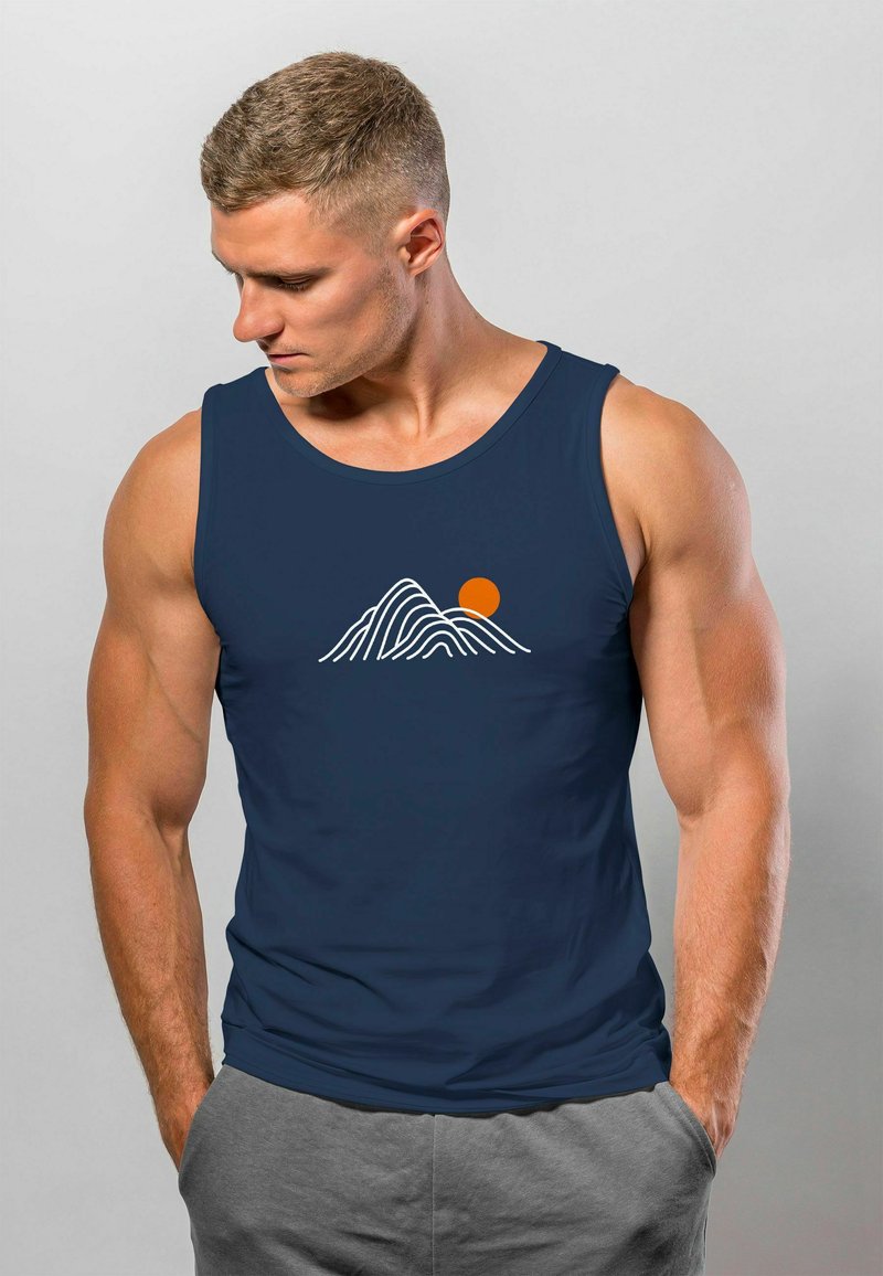 Navy blue tank top featuring a white mountain range graphic and an orange sun. Made from soft fabric, designed for comfort and utility.