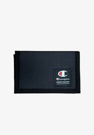 Portafoglio in tessuto nero piegato con toppa del logo Champion riportante "Authentic Athleticwear" nell'angolo in basso a destra.