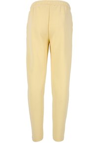 Gule bomulds-sweatpants med elastisk talje, der har en glat tekstur og tapered ben-design, velegnet til afslappet brug.