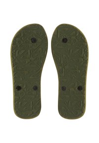 Semelles en caoutchouc vertes avec une surface texturée présentant des motifs géométriques et des inserts circulaires noirs pour la fixation. Design plat et contourné.