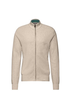 Beige vetoketjullinen neulepusero, jossa on teksturoitu neulekuvio, tealmärillä vuorattu pystykaulus sekä ribbaudu vaatteet hihansuut ja helma. Rinnassa on logo.