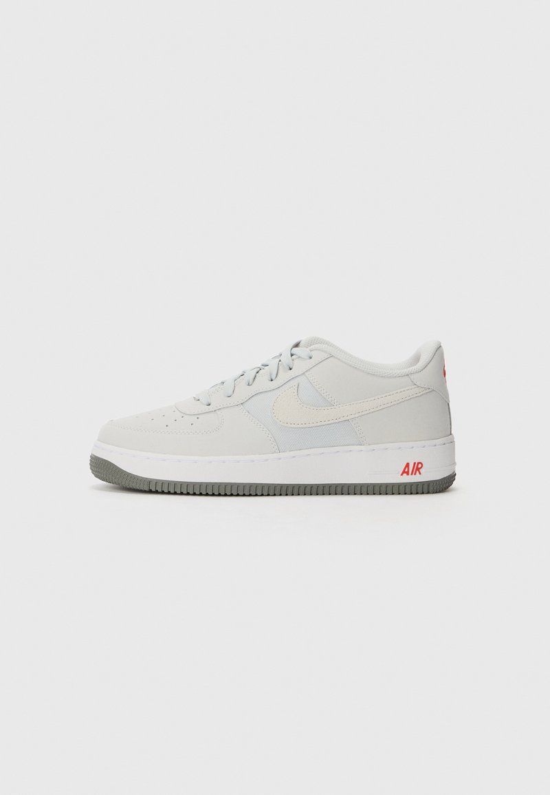 Light gray sneakers featuring a textured upper with suede and leather accents, a white midsole, and red "AIR" branding on the heel.