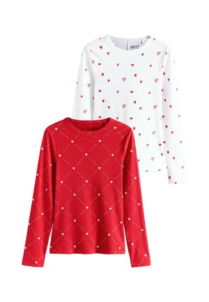 Two long-sleeve tops: one white with small red hearts and another red featuring a diamond pattern with tiny hearts. Cotton blend fabric.