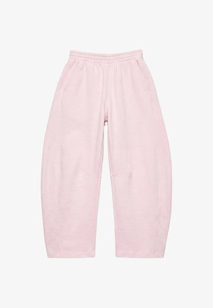 Pantalon de survêtement ample rose clair avec taille élastique et poches latérales, présenté à plat sur un fond blanc.