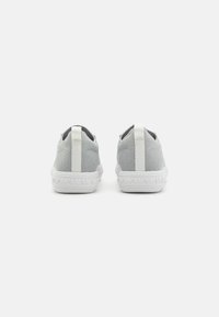 Scarpe slip-on grigie in rete con suola in gomma bianca e linguetta in tessuto sul tallone. Presentano una suola testurizzata con un design brandizzato.