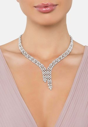 Silver-tone necklace with a Y-shaped design, featuring intricate crystal embellishments and a smooth, polished finish.