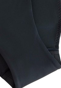 Černé plavecké šortky vyrobené z hladkého elastického materiálu s jemným povrchem a plochými švy pro pohodlí. Žádné viditelné vzory ani kovové detaily.