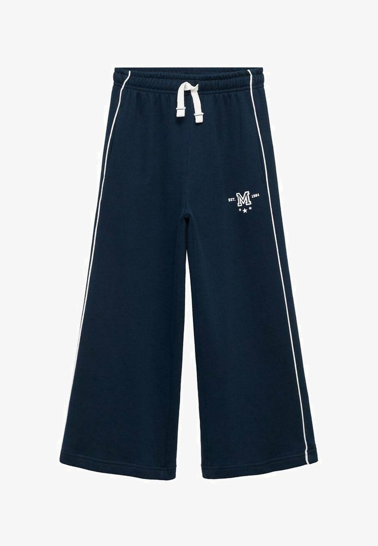 Navy modri široki trenirka z belimi stranskimi črtami in s pasom na vrvico. Ima majhen logotip z napisom "EST. 1984" in obliko zvezd.