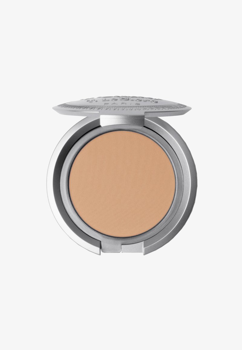 Compact powder with a round silver case, featuring an embossed design on the lid. The powder itself is a light beige color with a smooth texture.