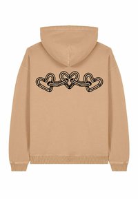 Felpa beige con un'illustrazione nera di cuori intrecciati sul retro. Tessuto morbido, maniche lunghe e cappuccio con lacci.