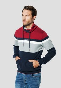 Bluza z kapturem w blokach kolorów: bordowym, szarym i granatowym. Posiada przednią kieszeń, sznurki i prążkowane mankiety. Wykonana z miękkiej bawełnianej tkaniny.