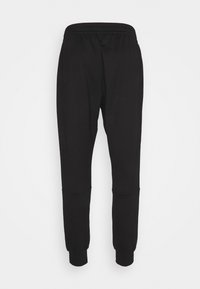 Svarta joggerbyxor med elastisk midja, tapered ben, ankle cuffs och utan synliga mönster eller accentfärger. Gjorda av mjukt tyg.