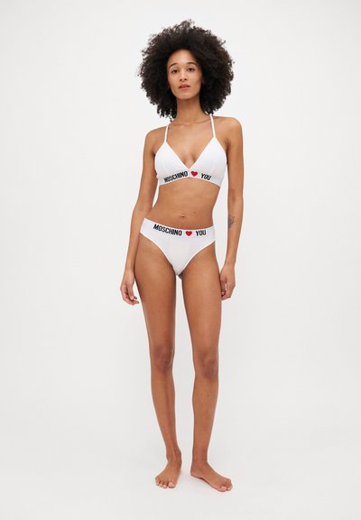 White bikini set featuring a bralette with thin straps and logo band, paired with low-rise briefs, both adorned with "MOSCHINO ♥ YOU" text.