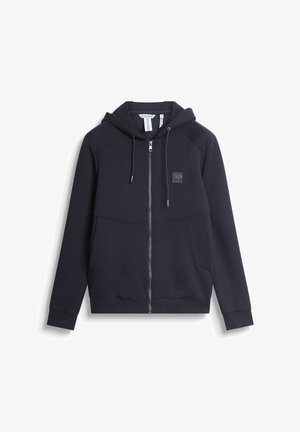 Tamno plava zip-up dukserica napravljena od mekog materijala, sa kapuljačom na vezanje, prednjim džepovima i malim logotipom na grudima.