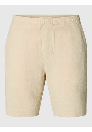 Short beige texturé jusqu'au genou avec une taille élastique et des détails subtils de couture devant.