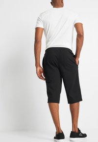 bonprix BERMUDA - Pantaloni sportivi - black