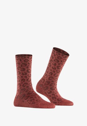 Red glitter socks with a leopard print design; mid-calf length, soft texture, and reinforced toe and heel areas.
