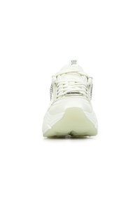 White sneakers with a chunky design, featuring a textured upper, lace closure, and silver chain accents on the sides. Clear rubber sole.