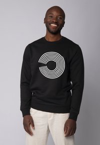 Schwarzes Sweatshirt mit einem weißen Grafikdesign aus konzentrischen Kreisen. Mit langen Ärmeln und Rundhalsausschnitt. Glattes Material, lockere Passform.