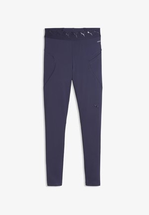Leggings de sport bleu marine avec taille haute, ornés de logos Puma blancs et poches latérales, fabriqués en tissu extensible lisse.