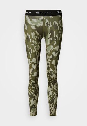 Leggings camouflage dans des nuances de vert et beige. Conception ajustée avec une ceinture noire marquée "Champion." Matière lisse et extensible.