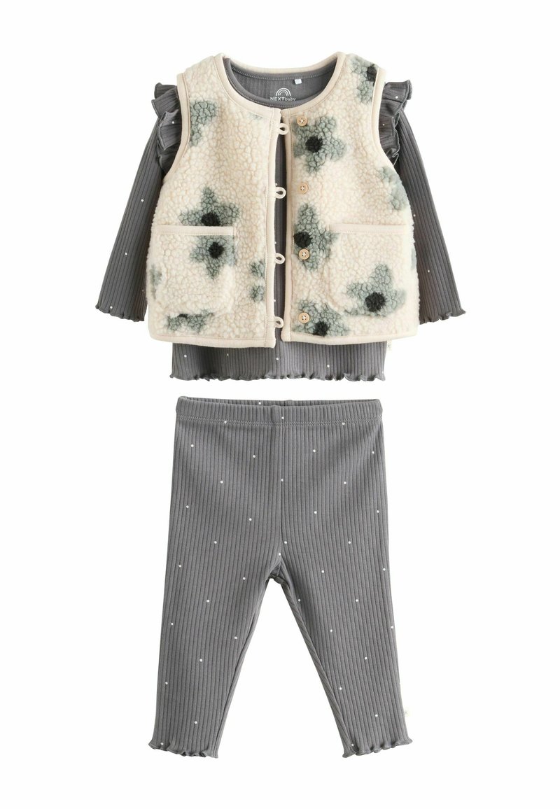 To-delt børnetøjssæt med en tekstureret fleecevest med blomstermønster i creme og mørkegrøn, parret med grå ribbede leggings med hvide prikker.
