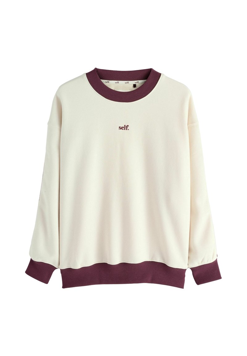 Kremowa bluza z ribbowanym dekoltem i mankietami w kolorze maroon. Posiada haftowane logo "self." w kolorze maroon z przodu. Miękka tekstura i luźny krój.