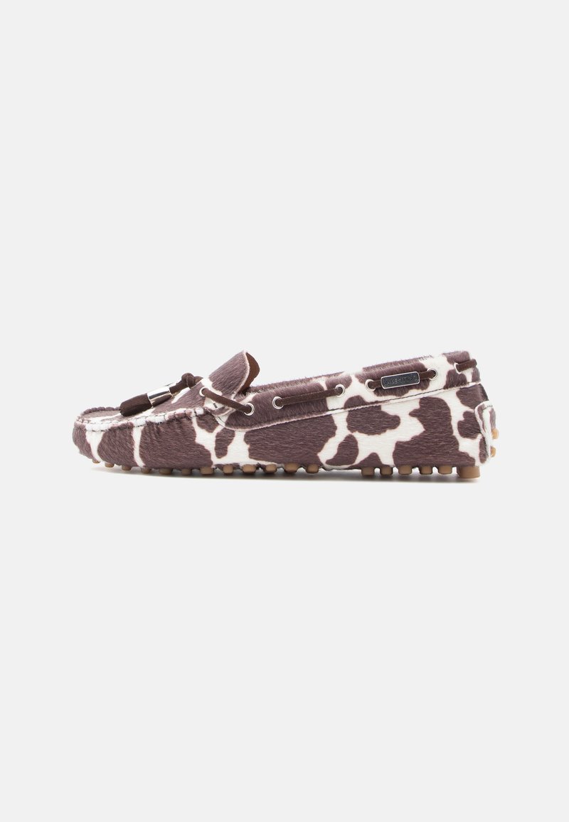 Brown and white cow-print moccasin loafer with leather laces and rubber pebble sole on a white background.