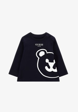 T-shirt manches longues bleu marine pour tout-petit avec logo GUESS blanc et grand visage d'ours blanc contourné sur le devant, boutons-pression à l'épaule.