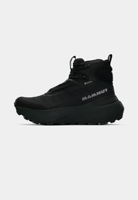 Black high-top hiking shoe with a textured fabric upper, featuring a Gore-Tex label, lacing system, and a chunky rubber sole for traction.