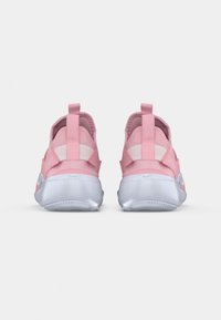 Różowe buty sportowe z gładką tekstylną cholewką, elastycznymi paskami i metaliczno-srebrną gumową podeszwą. Z tyłu znajdują się pętle ułatwiające zakładanie.