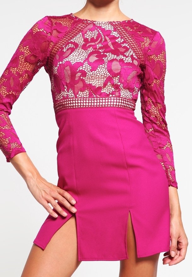 Fuchsiové šaty s dlouhými krajkovými rukávy a krajkovým živůtkem, přičemž mají přiléhavou sukni a dva rozparky na stehnech pro moderní siluetu.