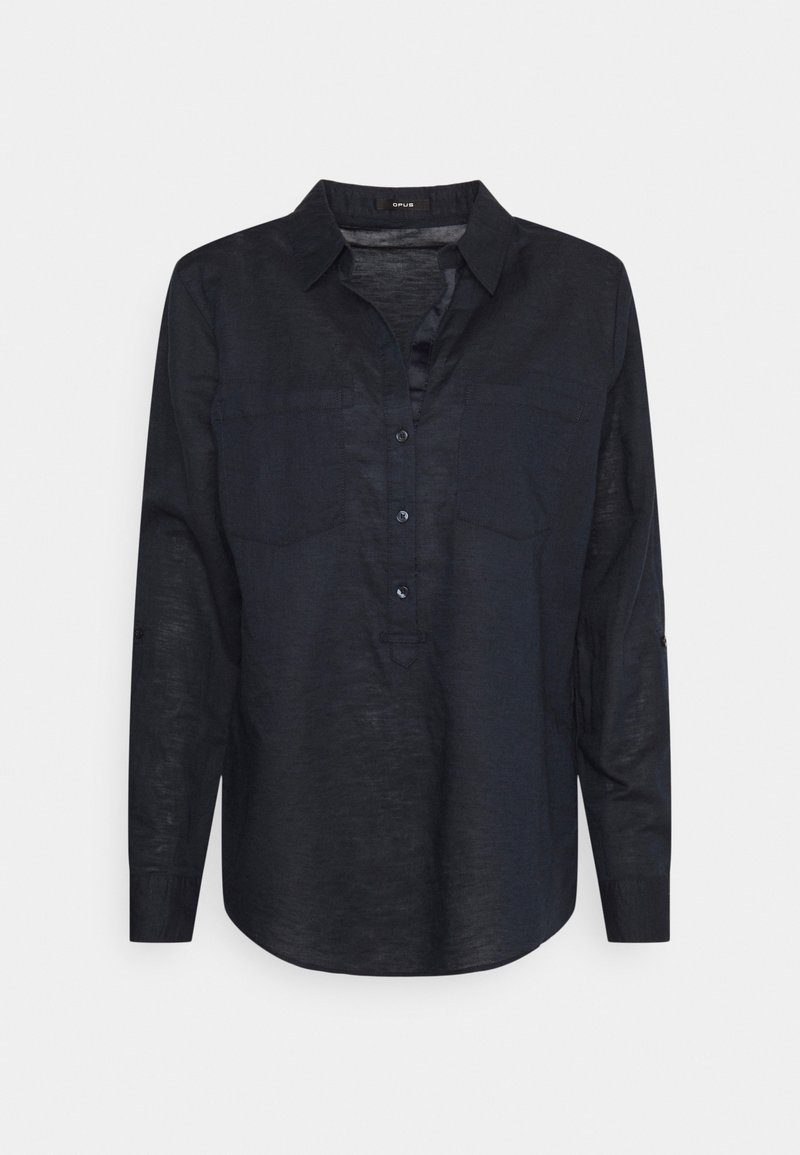 Chemise noire à manches longues avec col, quatre boutons devant et deux poches poitrine, présentée sur un fond clair uni.