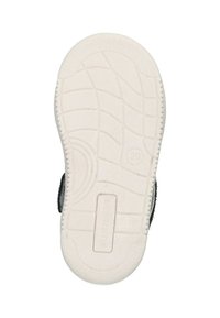Semelle en caoutchouc blanche avec un motif texturé, présentant un design de grille en relief et un logo estampé lisant "BUNNIE JR" sur le côté.