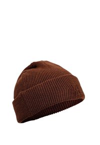 Brown knit beanie with a textured finish, featuring a rolled cuff and rounded top. Material appears soft and flexible.