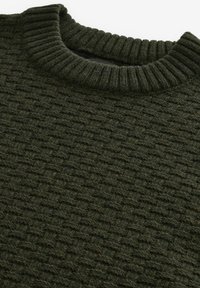 Dark green knit sweater featuring a textured pattern, round ribbed neckline, and thick yarn, highlighting its soft, warm material.