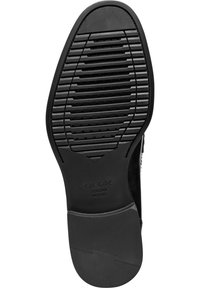 Sole in gomma nera con scanalature orizzontali e verticali, dotata di piccoli fori di ventilazione e logo impresso. Testurizzata per una migliore aderenza e durata.