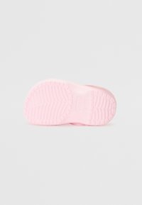 Pink rubber outsole with textured tread pattern, featuring grooves and ridges for traction. Lightweight design, rounded shape.