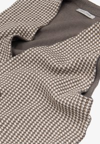 Brun og creme mønstret strikket vest med en blød tekstur, udstyret med en dyb V-hals og uden lukninger. Producentens label synlig indeni.