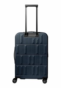 Maleta rígida de color azul marino con frente geométrico texturizado, asa retráctil y cuatro ruedas giratorias.