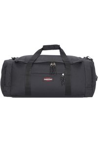 Black duffel bag made of durable fabric featuring two handles, a zipper closure, and an adjustable shoulder strap. Eastpak logo on front.