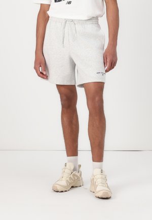 Light grey cotton shorts with a drawstring waist, featuring a small navy logo on the bottom hem and a relaxed fit.
