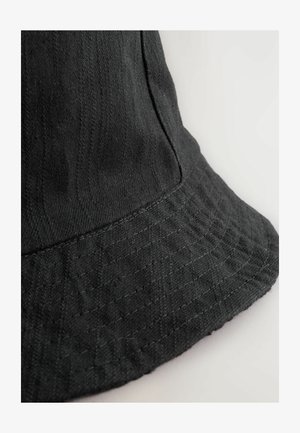 Black fabric bucket hat with a wide brim, textured finish, and subtle stitching details along the edge. Designed with a structured shape.