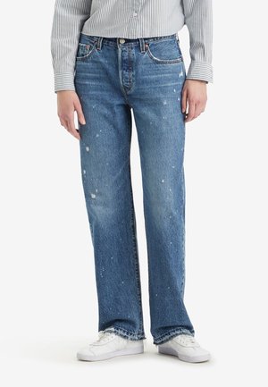 Light blue denim jeans with a straight leg, distressed look featuring paint splatters, five pockets, and a slightly frayed hem.