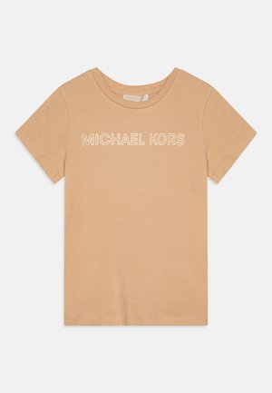 Beige tričko s krátkým rukávem a kulatým výstřihem, na hrudi s bílým nápisem "MICHAEL KORS" v obrysových písmenkách.