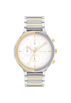 Montre-bracelet Calvin Klein bicolore argent et or avec cadran blanc, aiguilles dorées, sous-cadrans chronographes et bracelet à maillons métalliques.