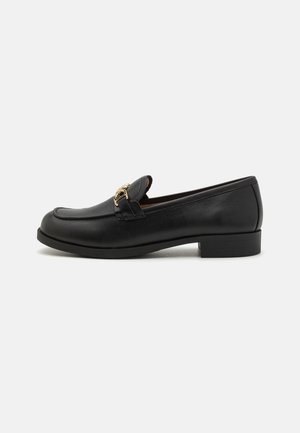 Black leather loafers with a low block heel, featuring a gold-toned hardware accent and a rounded toe design. Smooth texture throughout.