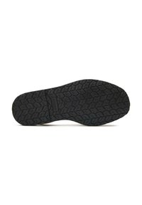 Black rubber shoe sole with a textured pattern, featuring grooves and ridges for traction. Smooth edges with a small manufacturer's label.