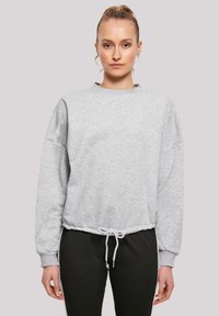 Grijze sweatshirt met een ronde hals, drop schouders en een verstelbare trekkoord aan de onderkant. Zacht materiaal en een relaxte pasvorm.